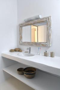 a bathroom with a sink and a mirror at Luxury Paros Villa Villa Aethra Beautiful & Serene Glisidia in Kampos Paros +27 photos