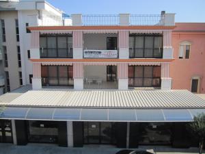 a building with an awning in front of it at La Veranda in Margherita di Savoia +12 photos