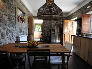 a kitchen with a table with a bowl of fruit on it at Beautiful Ponte De Lima Villa 4 Bedrooms Villa Hermosa Vista Private Pool in Ponte de Lima