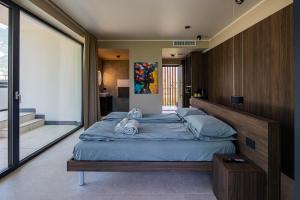 a bedroom with a large bed with two stuffed animals on it at Vinea Rural Resort - Adults only in Arco +153 photos