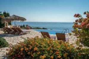 a group of chairs sitting next to a swimming pool at Extravagant Zante Villa Villa Crystal Great Sea Views 3 Bedrooms Agios Nikolaos in Koríthion
