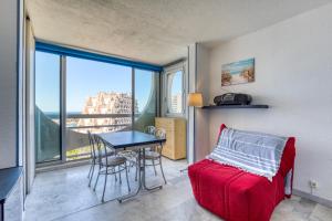 une chambre avec un lit, une table et une fenêtre dans l'établissement Sur les hauteurs du Fidji, à La Grande Motte