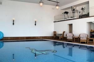 a swimming pool with a bird painted on the water at Magnificent Funchal Villa Villa Luzia 5 Bedrooms Sea & City Views in Funchal