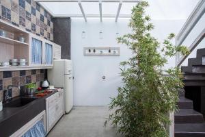 a kitchen with a tree in the middle of it at Elegant Astypalaia Villa Villa Ble Air Conditioning Hot Tub in Astypalaia Town