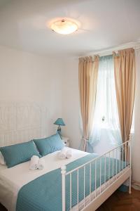 a bedroom with a bed and a window at Apartment Soul Of The City in Šibenik