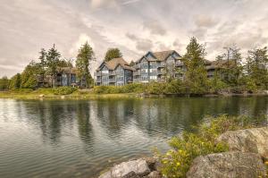 a large apartment complex next to a body of water at Waters Edge Shoreside Suites in Ucluelet