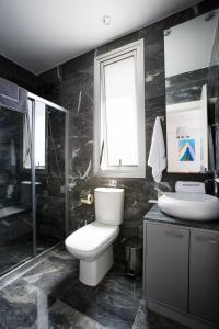 a bathroom with a toilet and a shower and a sink at Luxury Cyprus Villa Turquoise Villa Private Pool Sea View Paphos in Paphos