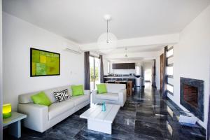 a living room with white furniture and a fireplace at Luxury Cyprus Villa Turquoise Villa Private Pool Sea View Paphos in Paphos