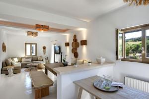 a living room with a couch and a table at Executive Paros Villa Villa Aiolos Private Pool & Jacuzzi Villa Kostos Damouli in Kampos Paros