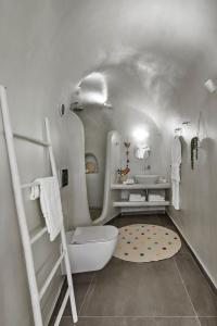 a bathroom with a white toilet and a sink at Finikia -Foinikia - Luxury Cave - A Wonderful 2 Bedroom Villa - Hot Tub in Foinikiá +20 photos