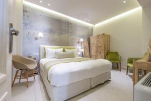a bedroom with a large white bed and a desk at Luxury Santorini Villa 4 Bedroom Villa Secluded Location & Private Pool Megalochori in Megalokhori +12 photos