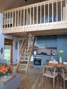 a loft bed in a kitchen and a dining room at Dolina nad Drawa in Przeborowo