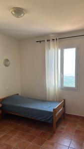 a bed in a room with a window at Gîte U Saltu in Solaro +6 photos