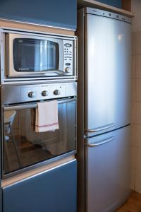 a stainless steel oven with a microwave and a refrigerator at Trilocale Abruzzi 6 Riccione in Riccione