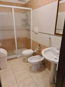 a bathroom with a toilet and a sink and a shower at La Veranda in Margherita di Savoia