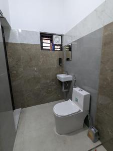 a bathroom with a toilet and a sink at Gods Gift Homestay James Inn in Kozhikode