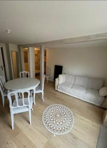 a room with a bed and a table and chairs at Appartement centre ville in Vayrac