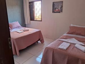 a room with two beds and a window at Apto ao lado da Praça da Sé, ótima localização in Crato
