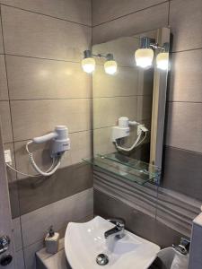 a bathroom with a sink and a mirror at Victoria's Blue studios in Siviri +79 photos