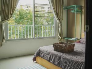 a bedroom with a window and a basket on a bed at Boxsoon Nimman 3 # 4beds 4baths in Chiang Mai +60 photos