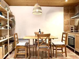 a kitchen with a wooden table and chairs at La Caseta de Palamós in Palamós