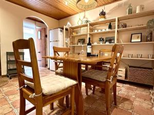 a dining room with a wooden table and chairs at La Caseta de Palamós in Palamós +23 photos