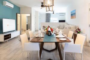a dining room and living room with a table and chairs at Royal St. Kitts Hotel in Frigate Bay