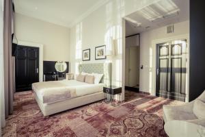a bedroom with a white bed and a mirror at Craft Beer Central Hotel in Gdańsk +44 photos