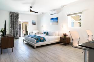 a bedroom with a bed and a table and chairs at Royal St. Kitts Hotel in Frigate Bay