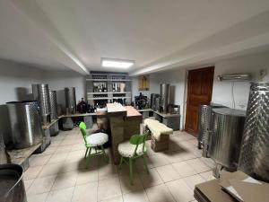 a kitchen with green chairs and tables in a room at Sebe apartments 5 in Holíč