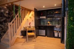 a kitchen with a table and a staircase with a table and chairs at L Indiana douche sensorielle in Le Muy