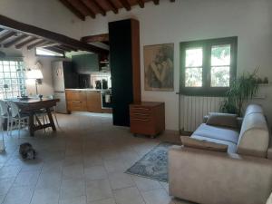 a living room with a couch and a table at La casa di Priscilla in Bucine +14 photos