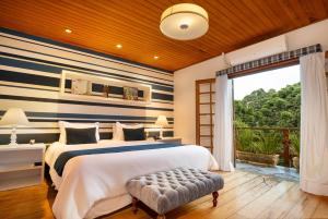 a bedroom with a bed with blue and white stripes at Pousada Apple House Campos do Jordao in Campos do Jordão