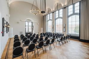 a room with rows of chairs in a room with large windows at Craft Beer Central Hotel in Gdańsk