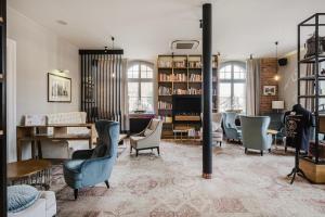 a living room filled with lots of furniture at Craft Beer Central Hotel in Gdańsk