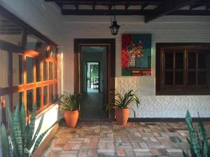a front door of a house with potted plants at Casa de Campo & Home Office - Itapecerica da Serra , perto do Embu das Artes in Itapecerica da Serra