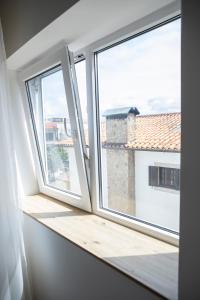a room with three windows with a view at Residencial Princesa do Ave in Vila do Conde