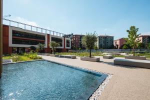 a building with a swimming pool in front of a building at Park Towers 15 - Design - Large Terrace - AC in Milan