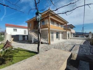 ein Haus mit einem Baum davor in der Unterkunft Barcelos Habadia Espigueiro in Lijó