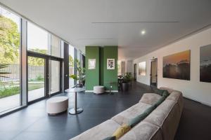a living room with a large couch and some windows at Park Towers 15 - Design - Large Terrace - AC in Milan