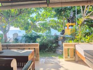 a patio with a view of the ocean at Solaluna Beach Homestay in Amed