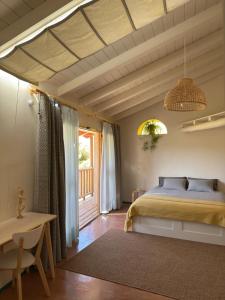 a bedroom with a bed and a table at Bellísima cueva acogedora "Casa Olivia" in Gor +55 photos