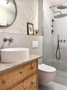 a bathroom with a sink and a shower at Servus O´gau Apartments in Oberammergau +51 photos
