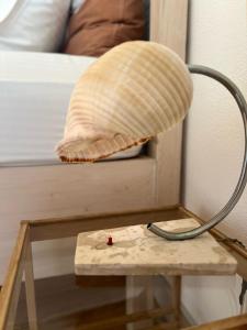 a lamp sitting on a table next to a bed at Himara Hostel in Himare