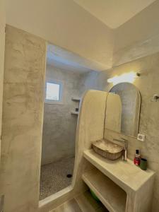 a bathroom with a sink and a mirror at Marianna Studios in Donoussa