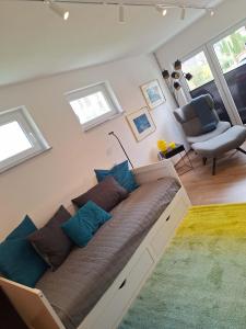 a large couch in a room with windows at Home between lakes in Mattsee +11 photos