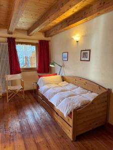 a bedroom with a large wooden bed in a room at La Thuillettaz B&B in Saint-Rhémy-en-bosses +55 photos