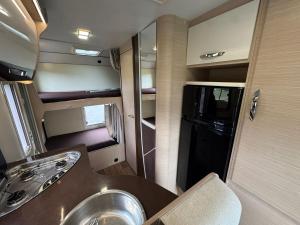 a kitchen with a sink and a refrigerator in an rv at Fiat Mc Louis Camper Van RV in Reykjavík