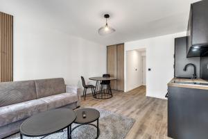 a living room with a couch and a table at Studio de charme rénové calme et lumineux in Thonon-les-Bains +7 photos