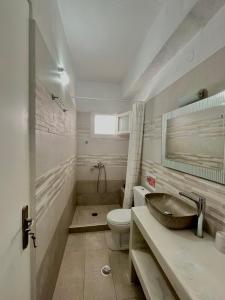 a bathroom with a sink and a toilet at Marianna Studios in Donoussa